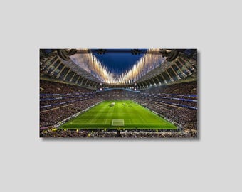 May include: A large, modern stadium with a green football pitch and a crowd of people in the stands. Fireworks are exploding in the sky above the stadium.