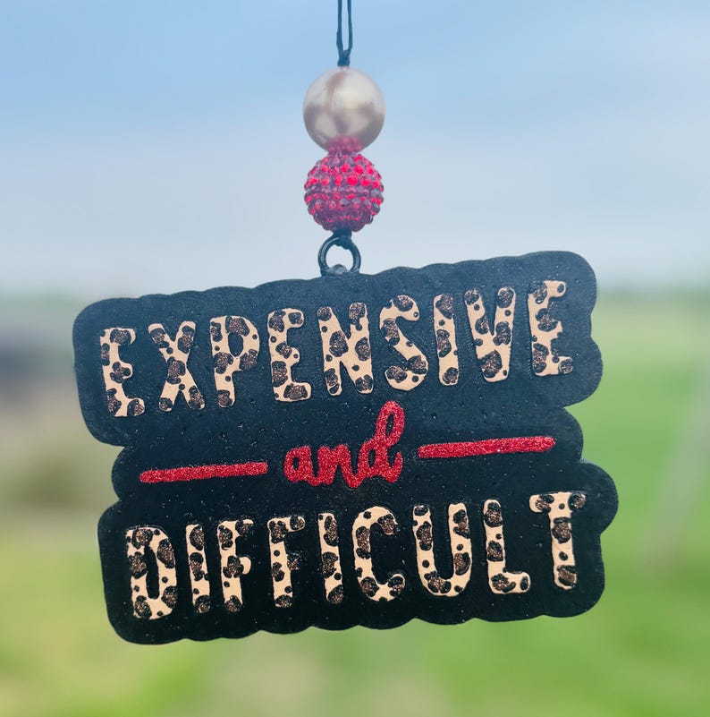 May include: A handmade, wooden cutting board with a natural finish. The board features a live edge on one side and a rectangular shape. It is approximately 18 inches long, 12 inches wide, and 1 inch thick.