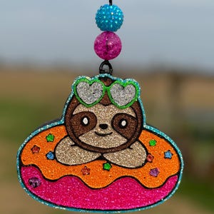 May include: A white ceramic mug with a black handle and the text "But First, Coffee" in a bold, black font. The mug is set against a neutral background, highlighting its simple design.