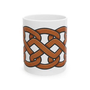 May include: A white ceramic mug featuring a continuous brown Celtic knot pattern wrapped around the center. The design consists of interlocking loops with dark outlines, creating a repeating geometric motif against the plain white background.