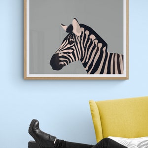 May include: A framed print of a black and white zebra with a gray background. The zebra is facing to the right and its head is tilted slightly. The print is hanging on a light blue wall above a yellow armchair.
