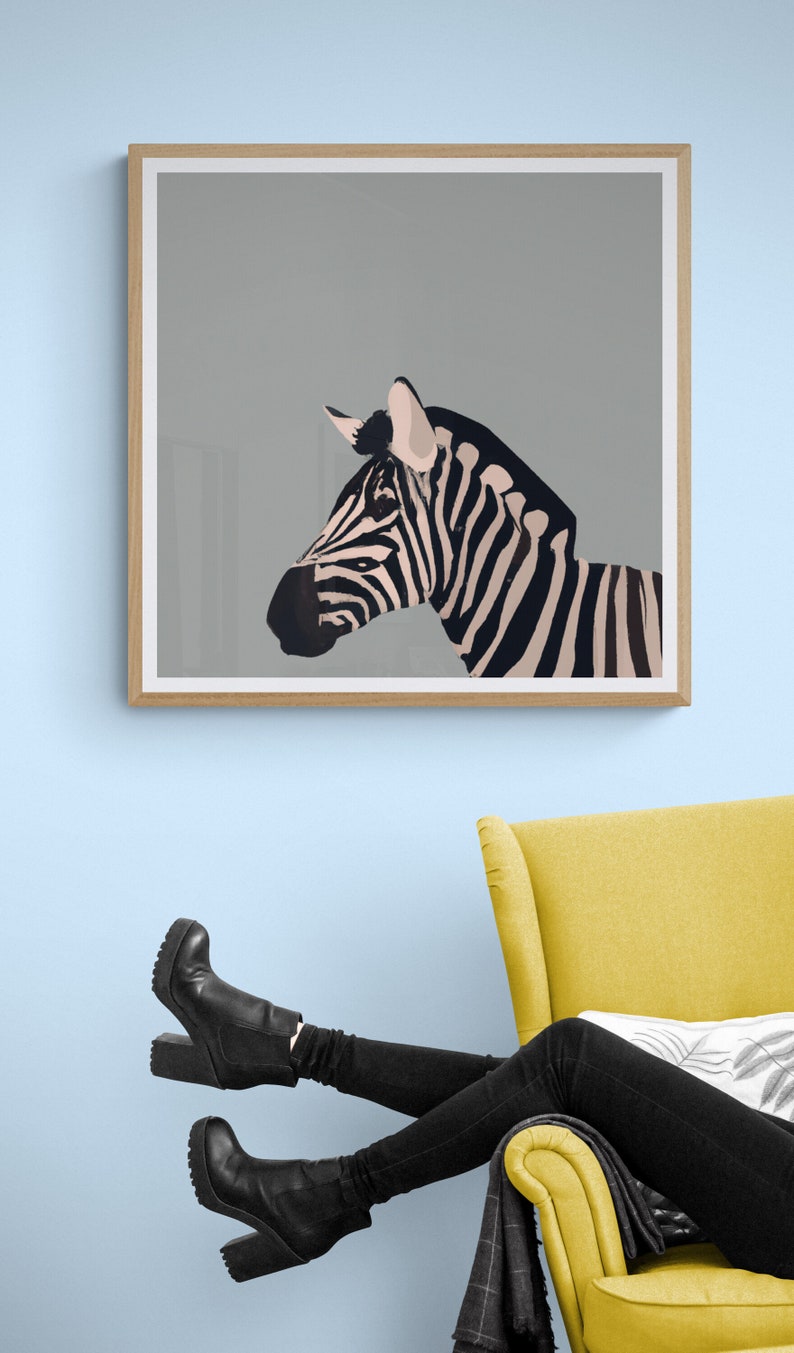 May include: A framed print of a black and white zebra with a gray background. The zebra is facing to the right and its head is tilted slightly. The print is hanging on a light blue wall above a yellow armchair.