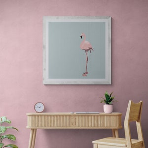 May include: A framed print of a pink flamingo standing on one leg against a light blue background. The frame is white and has a simple design.