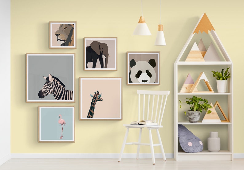 May include: A yellow wall with a white chair and a white bookshelf. The wall is decorated with framed animal prints of a lion, elephant, zebra, giraffe, flamingo, and panda. The bookshelf has wooden mountain-shaped decorations and plants.
