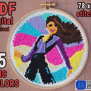 Puede incluir: Un patrón de punto de cruz con una mujer vestida de morado y negro, sobre un fondo colorido. El diseño está enmarcado en un aro de madera. El texto incluye "PDF digital download", "15 DMC COLORS" y "78 x 79 stitches".