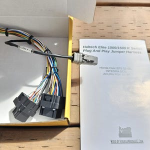 May include: A Haltech Elite 1000/1500 K Series Plug And Play Jumper Harness for Honda Civic EP3 02-05, Integra DC5, and Acura RSX 02-04. The harness is in a yellow box with a white instruction sheet. The harness has a black connector with multiple wires.