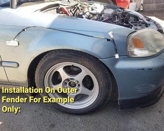 May include: A close-up of a gray car with a black wire running along the fender. The car has a silver rim and the text "Installation On Outer Fender For Example Only:" is visible in the image.