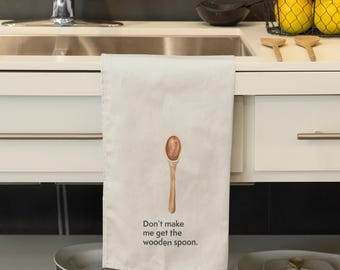 May include: A white kitchen towel with a brown wooden spoon and the text "Don't make me get the wooden spoon."