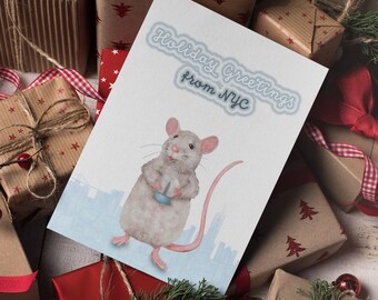 May include: A festive greeting card with a watercolour illustration of a grey rat holding a small blue object, with the text "Holiday Greetings from NYC." The card is surrounded by wrapped gifts with red and brown paper and ribbons.