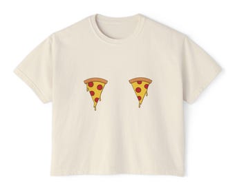 May include: A cream-coloured cropped t-shirt with a graphic of two pizza slices with red pepperoni and melted cheese.