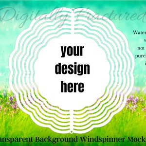 May include: A white wind spinner mockup with a circular design. The background is a blurred image of a green field with purple flowers. The text "your design here" is in the center of the wind spinner.
