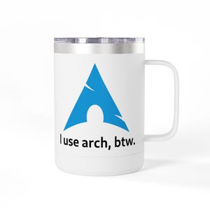 May include: A white cylindrical mug with a metallic rim and handle, featuring a blue triangular logo and the black text "I use arch, btw." printed on the front. The mug has a smooth finish and a sturdy side handle for holding the beverage container.