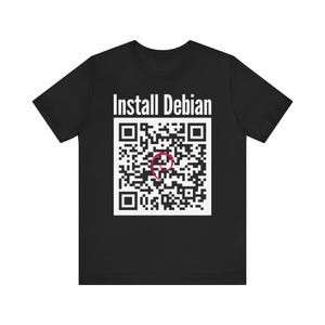 May include: A black short-sleeved t-shirt featuring the white text Install Debian above a large square QR code. Centered within the QR code is a small red swirl graphic. The design is printed on the front of the solid black cotton fabric.
