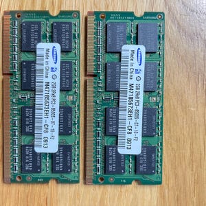 May include: Two green Samsung 2GB 2Rx8 PC3-8500S-07-10-F2 RAM modules with the text "Made in China" and "M471B5673EH1-CF8 0913" printed on them.