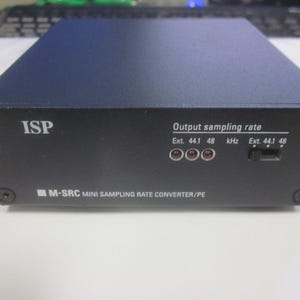 Könnte beinhalten: Ein schwarzes ISP M-SRC MINI SAMPLING RATE CONVERTER/PE Gerät mit einem silbernen Etikett und drei silbernen Knöpfen. Das Etikett lautet "Output sampling rate Ext. 44.1 48 kHz Ext. 44.1 48".