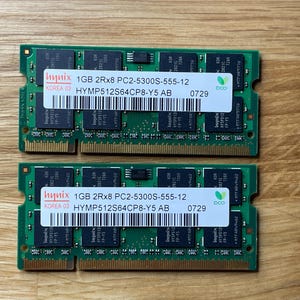 May include: Two green computer memory modules with black labels. The labels read "1GB 2Rx8 PC2-5300S-555-12 HYMP512S64CP8-Y5 AB 0729".
