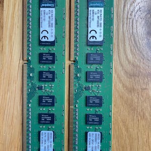 May include: Two green Kingston 8GB 2Rx8 PC3-10600E-9-13-E3 KTA-MP1333/8G 1.5/ BSMH1811501 memory modules. The modules have a black label with white text and a CE mark.