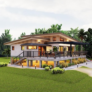 Op de afbeelding: Een modern, eenlaags huis met een houten terras en een betonnen fundering. Het huis heeft een witte buitenkant met bruine afwerking en grote ramen. Het terras is omgeven door weelderig groen landschap.
