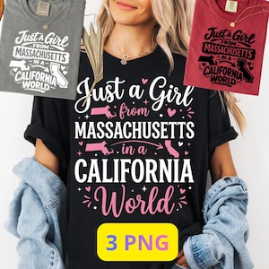 Peut inclure: T-shirt noir avec l'inscription "Just a Girl from Massachusetts in a California World" en blanc et rose. Le motif comprend des contours d'États et des éléments décoratifs. D'autres t-shirts gris et rouges sont également visibles.