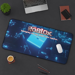 May include: A blue and black gaming mouse pad with a blue glowing block and the text "Roblox Reimagining the way people come together."