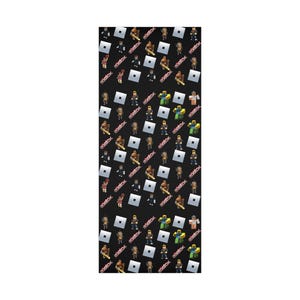 May include: A black fabric featuring a repeating pattern of various Roblox character figures, white square logos, and the red Roblox text logo scattered across the surface. The design consists of multiple small, colorful blocky avatars in different poses.