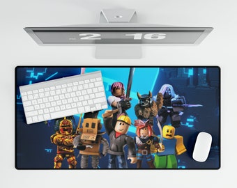 May include: A rectangular desk mat featuring a vibrant digital illustration of various blocky, stylized characters in a dark blue, tech-inspired environment. The mat is positioned under a white wireless keyboard and a white computer mouse.