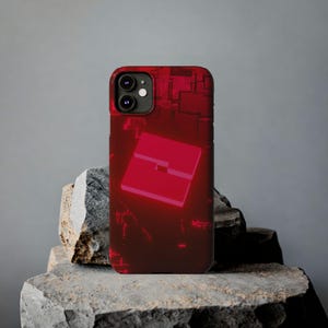 May include: Red iPhone case featuring a red, glowing, square-shaped design. The case has a textured, circuit board-like pattern.