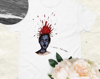 Può includere: Una maglietta bianca con una grafica di una persona con uno schizzo di sangue rosso sulla testa. Il testo "Ahhhh... That's better" è scritto sotto la grafica.