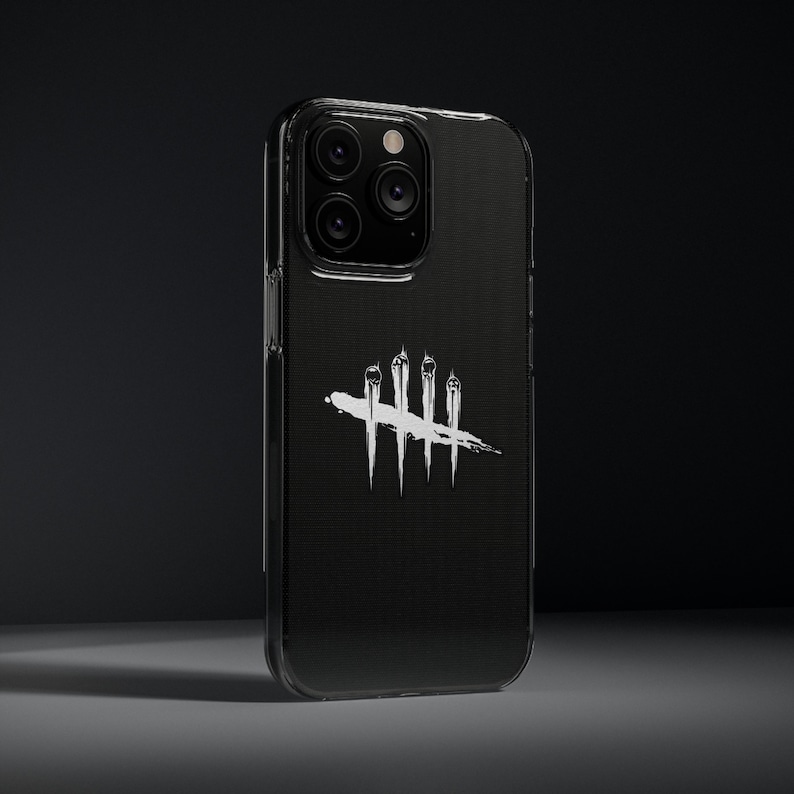 Puede incluir: Funda transparente para tel&eacute;fono con parte trasera negra. Tiene un gr&aacute;fico blanco de cuatro l&iacute;neas verticales con una l&iacute;nea horizontal que las atraviesa. La funda est&aacute; sobre un fondo oscuro.