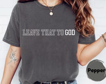 May include: A charcoal gray t-shirt with the text "LEAVE THAT TO GOD" in white outlined letters.