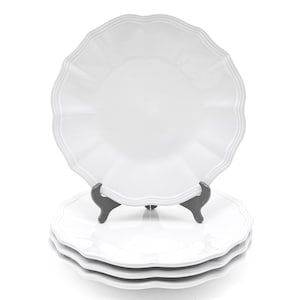 May include: Four white ceramic plates with a scalloped edge, one displayed on a black stand. The plates have a glossy finish. The plates are stacked, with a white background.