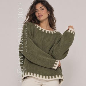 May include: An olive green long-sleeve knit sweater featuring a wide crew neckline, long sleeves, and a hemline accented with a white block-patterned border. The text KNITTORASTUDIO KNITTING PATTERNS is visible vertically along the left side.