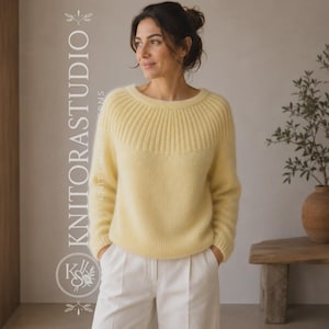May include: A pale yellow long-sleeved jumper featuring a ribbed knit yoke and a round neckline. The garment is paired with white trousers. The text KNITORASTUDIO is printed vertically on the left side of the image with a circular logo below.