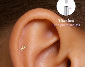 May include: Close-up of a person's ear with a small gold leaf push pin earring. The earring is made of titanium and is threadless. The image also shows a diagram of how to insert the push pin.