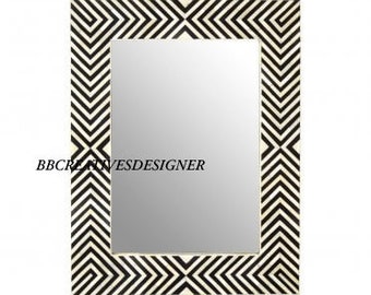 May include: Black and white geometric patterned mirror with a rectangular frame. The pattern is made of bone inlay.