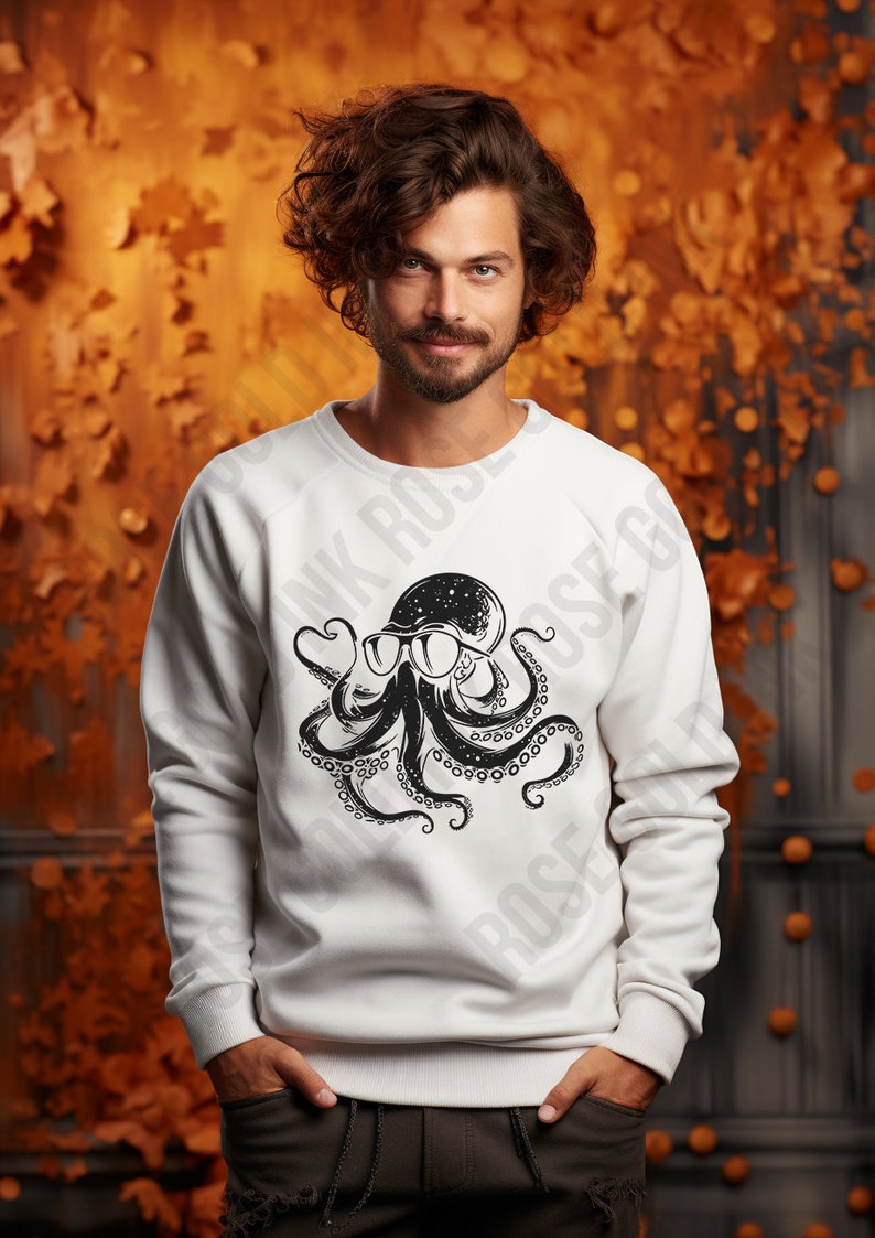 Puede incluir: Sudadera blanca con un estampado gr&aacute;fico de un pulpo negro con gafas de sol. El pulpo tiene un dise&ntilde;o de galaxia dentro de su cabeza.