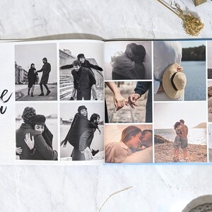 May include: Open photo album with a collage of black and white photos of couples. The album's left page has the words "Love you" with a pink heart. The right page has a blue border.