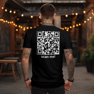 May include: A black t-shirt with a white QR code and the text "scan me!" printed on the back.