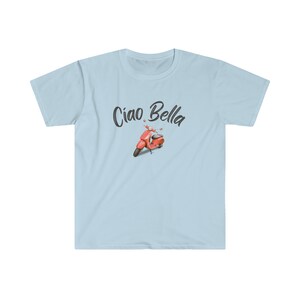 May include: A light blue t-shirt with the text "Ciao Bella" in black cursive font. A red scooter with black wheels is pictured below the text.