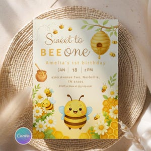 May include: A whimsical invitation with a bee theme. The text reads "Sweet to BEE One" with details for Amelia's 1st birthday. The design includes illustrations of bees, honeycombs, and flowers. The invitation is set against a neutral background.
