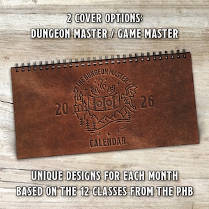 May include: A brown leather-bound calendar with a spiral binding. The cover features the text "THE DUNGEON MASTER" and the year "2026" with an embossed design of a castle, dice, and a dragon. Additional text reads "CALENDAR" and "UNIQUE DESIGNS FOR EACH MONTH BASED ON THE 12 CLASSES FROM THE PHB".