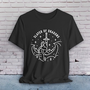 May include: Black t-shirt with a white graphic design of a dragon with a sword through it. The text "Slayer of Dragons" is written in a circle around the dragon.