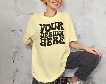 May include: A yellow oversized t-shirt with the text "YOUR DESIGN HERE" in a retro, black, distressed font.