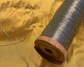 10 meters of antique pale blue metal embroidery thread.