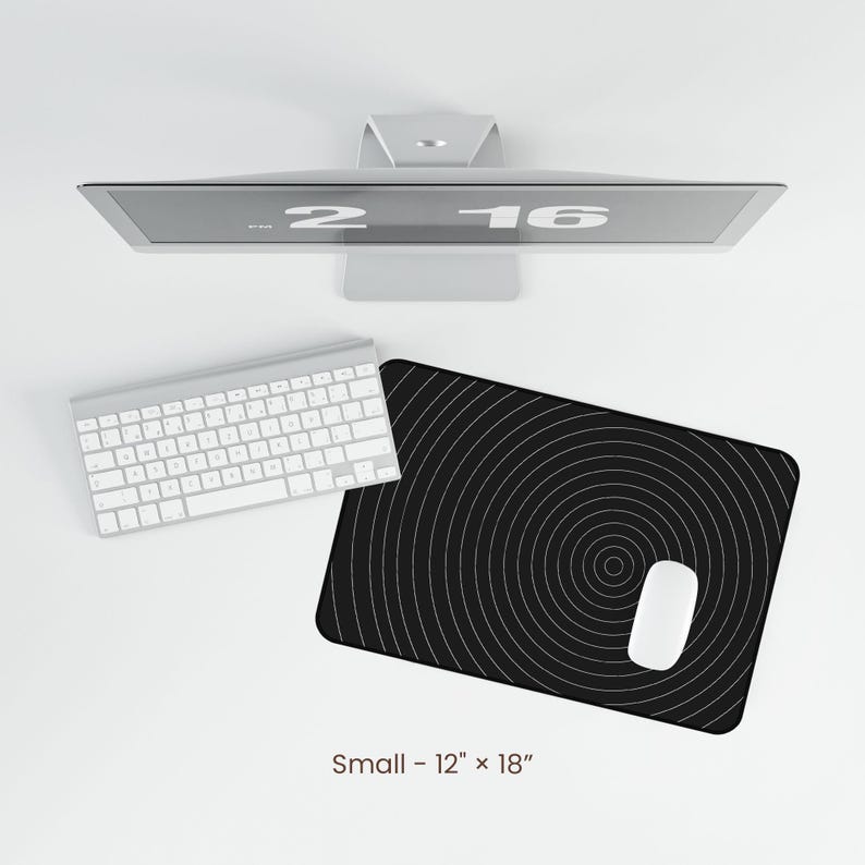 May include: A black and white circular pattern mouse pad with a white computer mouse on top. The mouse pad is 12 inches by 18 inches.