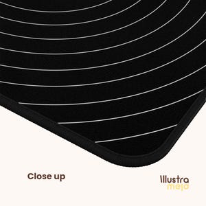 May include: Black and white mouse pad with a circular pattern of white lines on a black background. The mouse pad has a black stitched edge.