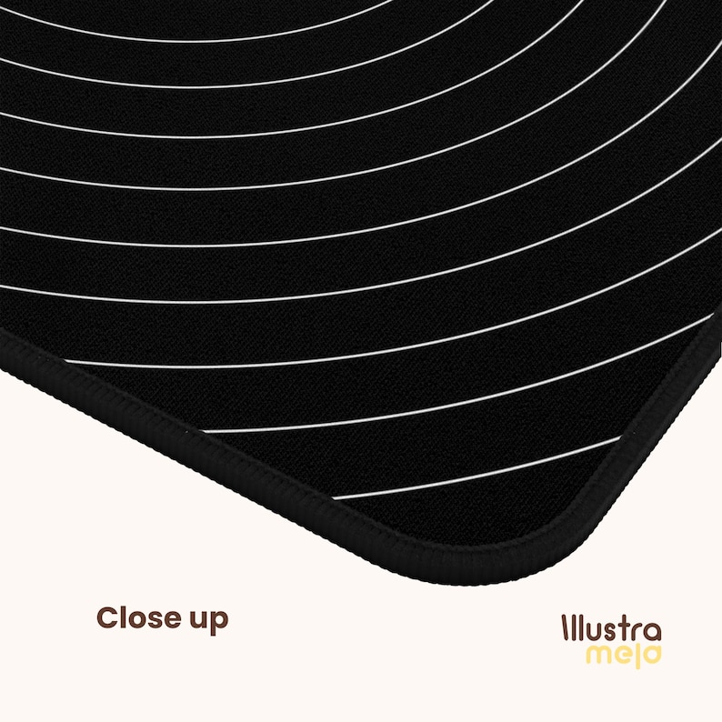 May include: Black and white mouse pad with a circular pattern of white lines on a black background. The mouse pad has a black stitched edge.