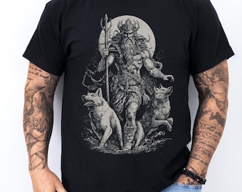 May include: Black t-shirt with a detailed illustration of a Norse god holding a trident, flanked by two wolves, set against a full moon. The design is in shades of grey and white.