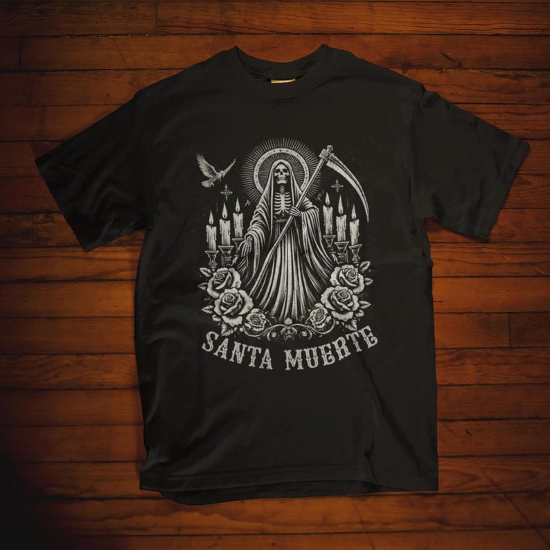 Santa Muerte Gothic Shirt - Holy Death T-Shirt featuring Day of the Dead skull design. Perfect Mexican folk art skeleton top for Dia de los Muertos celebrations or as a unique gift idea. Stylish and symbolic gothic tee for fans of Santa Muerte.