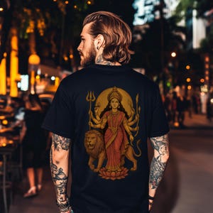 “Maa Durga T-shirt featuring the Hindu goddess of strength and protection, perfect for devotees of the divine feminine and Shakti power. Spiritual yoga clothing with sacred iconography, ideal for those seeking a powerful and meaningful Hindu goddess tee.